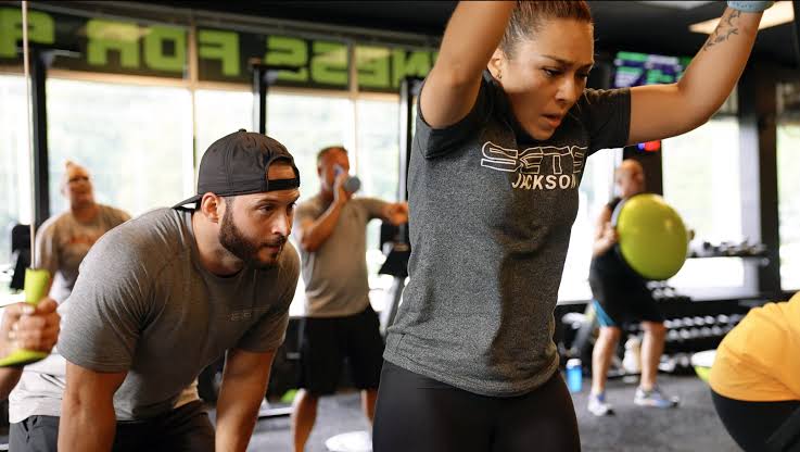 A group completing a team training workout at Iron & Co. Gym
